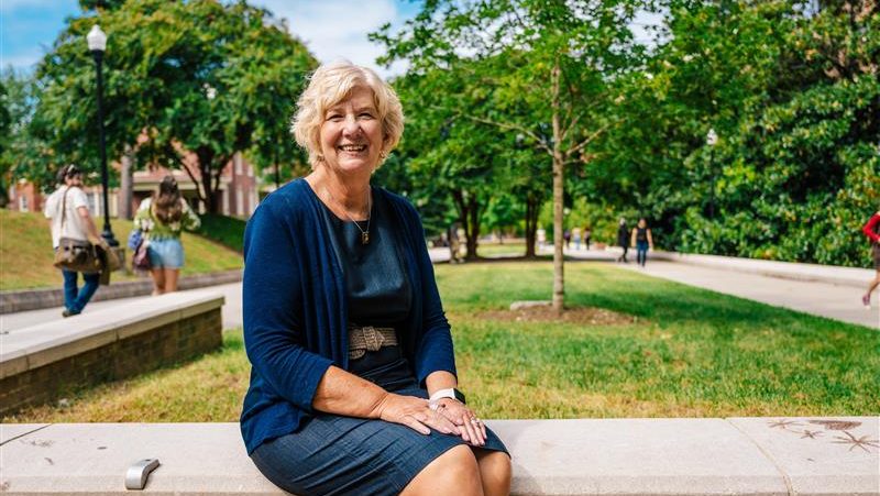 Woman sitting outside on UNCG campus